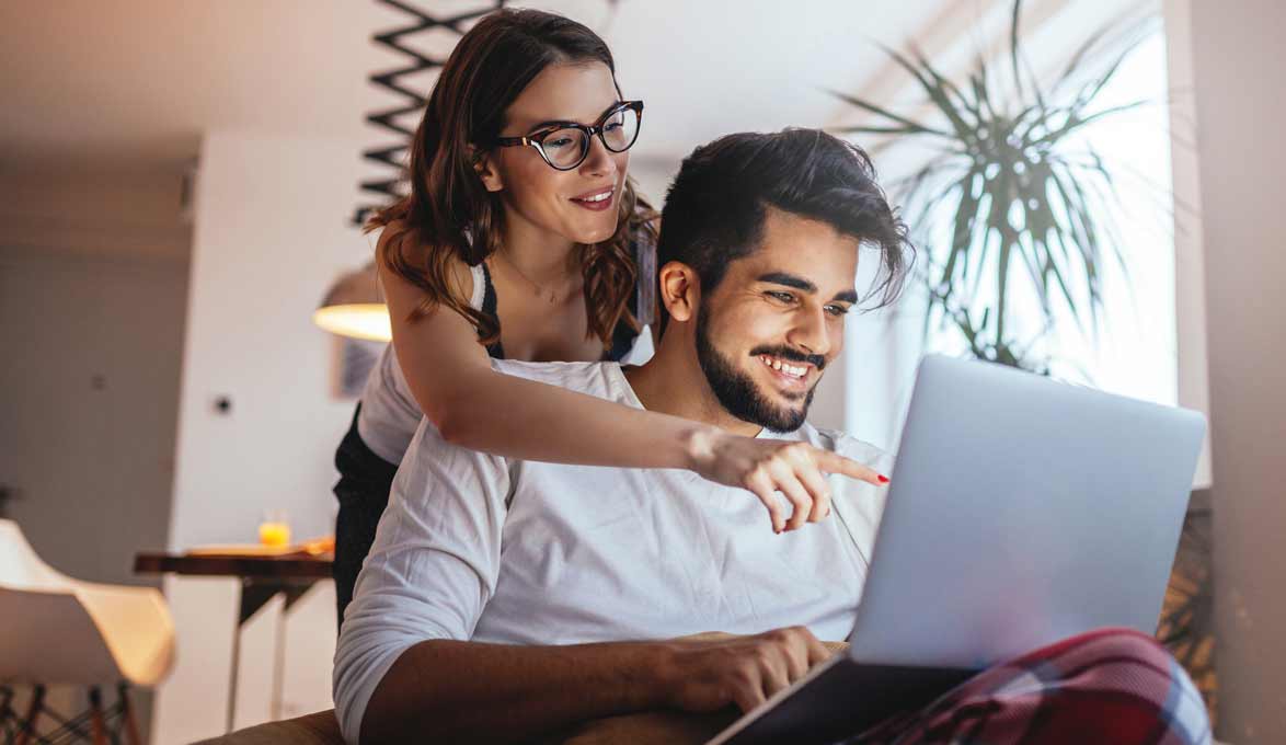 Couple on computer together.